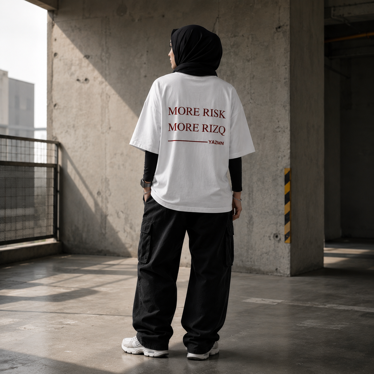 YAZMN white tee worn in concrete location